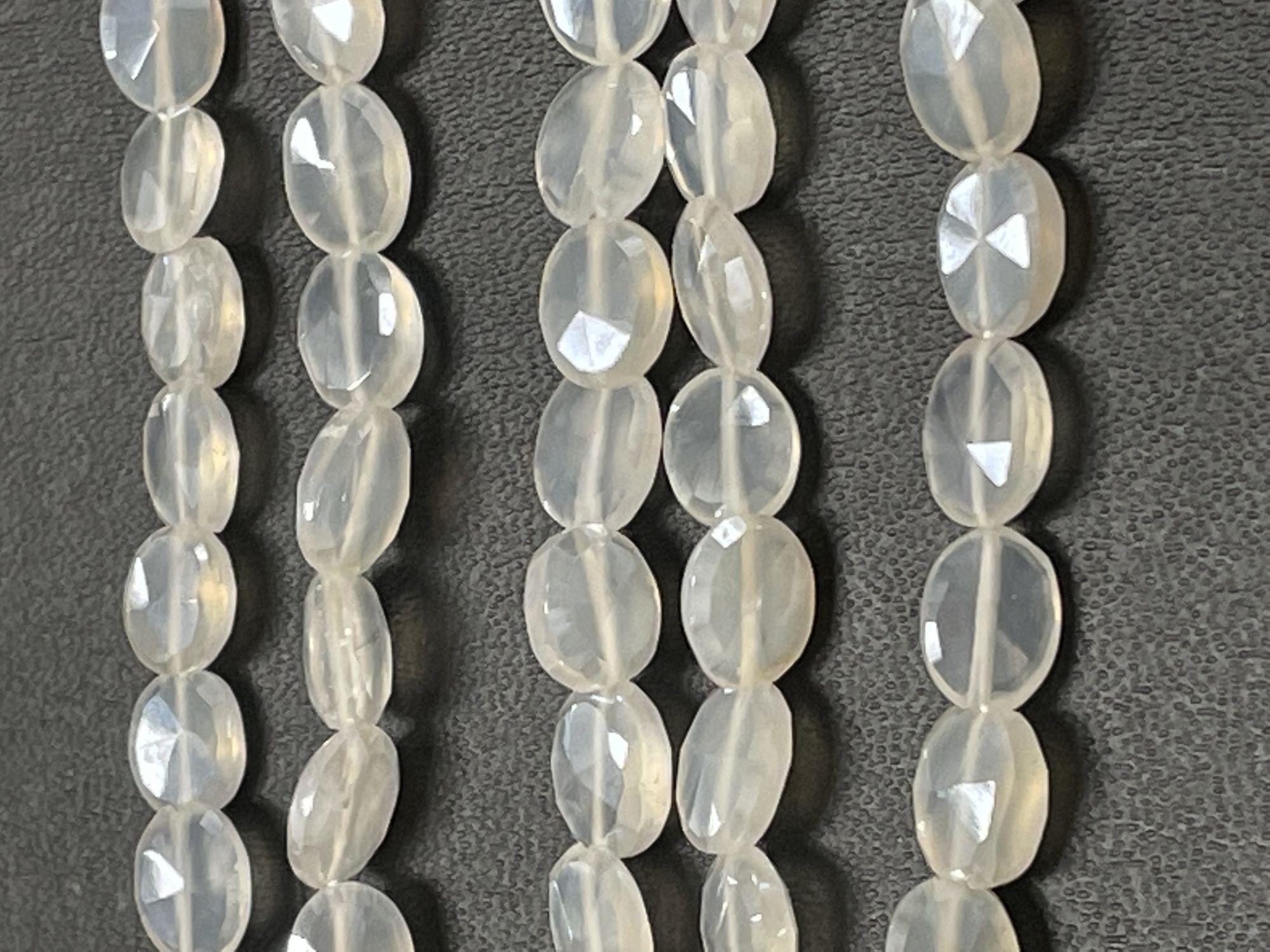 Coated Pearl White Chalcedony Oval Faceted