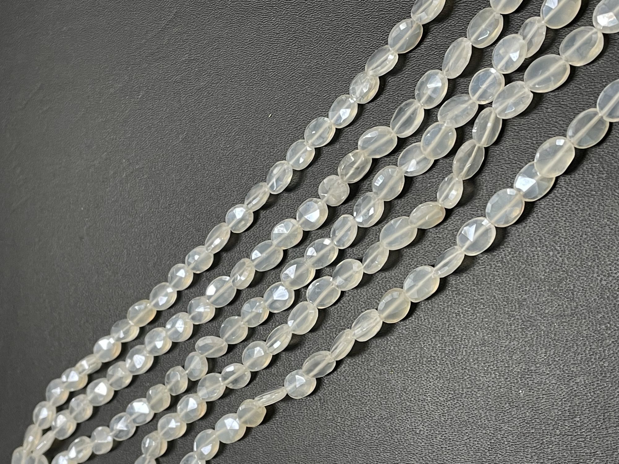 Coated Pearl White Chalcedony Oval Faceted